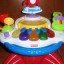 Fisher Price muzyczny stoliczek tańczaca małpka