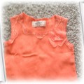 Pomarańczowa koszulka z kwiatuszkiem rozm74